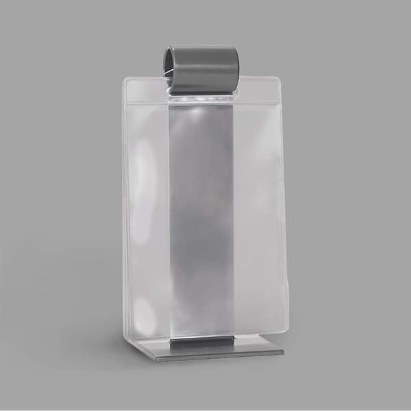 A gray plastic roll stand with a metal clip holding clear page protectors.