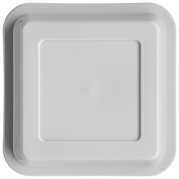 A white square plastic container lid with a small circle in the middle.