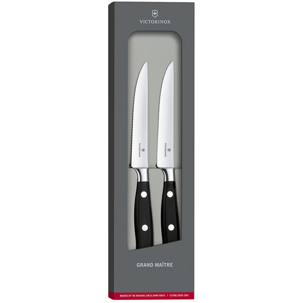 A set of two Victorinox Grand Maitre steak knives with white POM handles.
