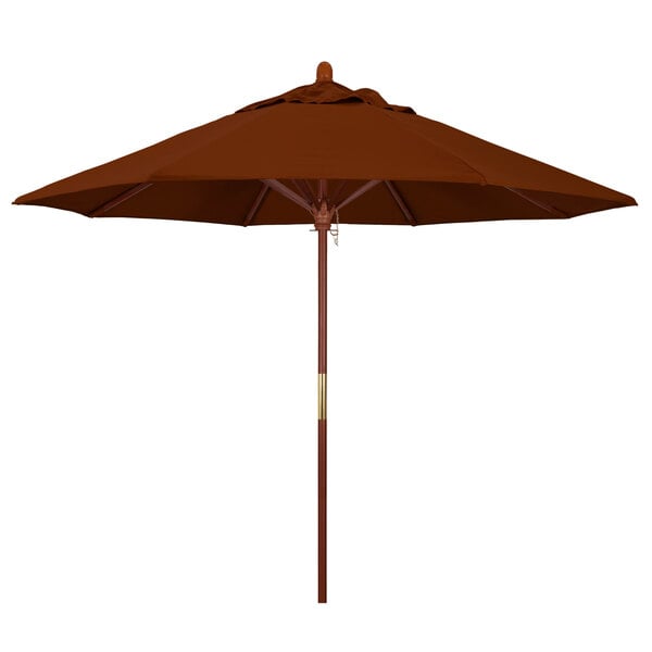 A close-up of a California Umbrella Pacifica brick fabric round umbrella with a hardwood pole.