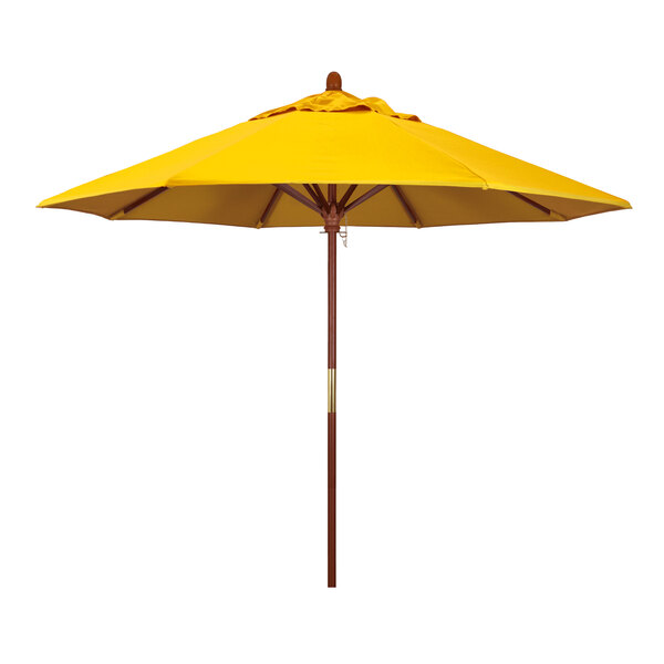 A close-up of a yellow California Umbrella with a wooden pole.