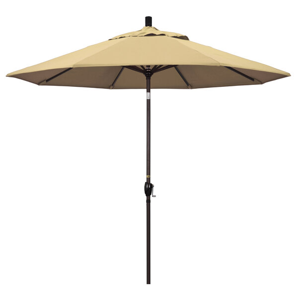 A beige California Umbrella with a bronze pole.