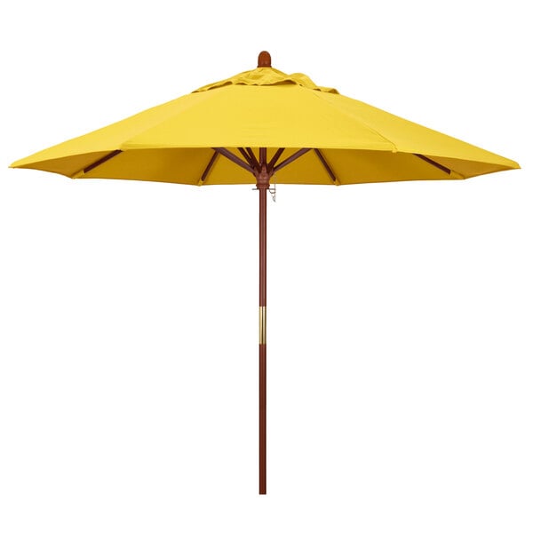 A close up of a yellow California Umbrella with a wooden pole.