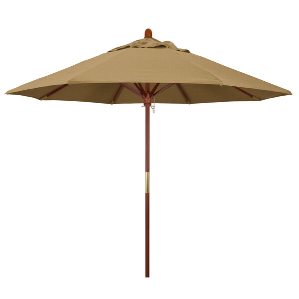 A brown umbrella with a straw canopy and wooden pole.
