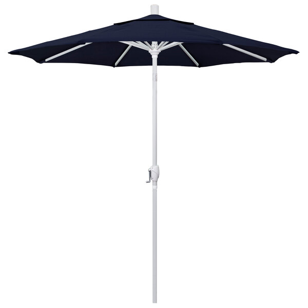 A navy blue California Umbrella on a white pole.