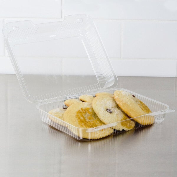 A Dart clear hinged plastic container of cookies.