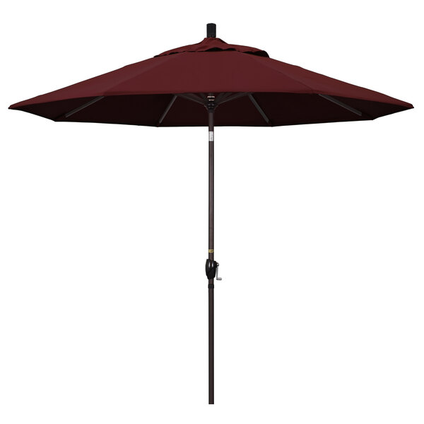 A close-up of a burgundy California Umbrella with a bronze pole.
