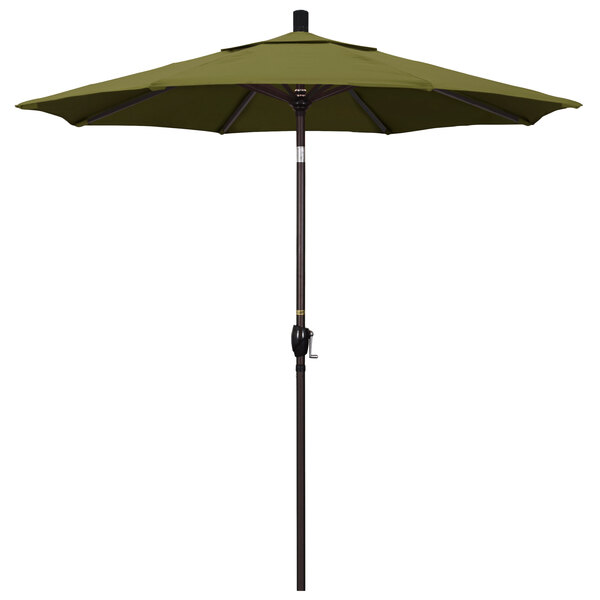 A green California Umbrella on a bronze pole with a palm pattern.