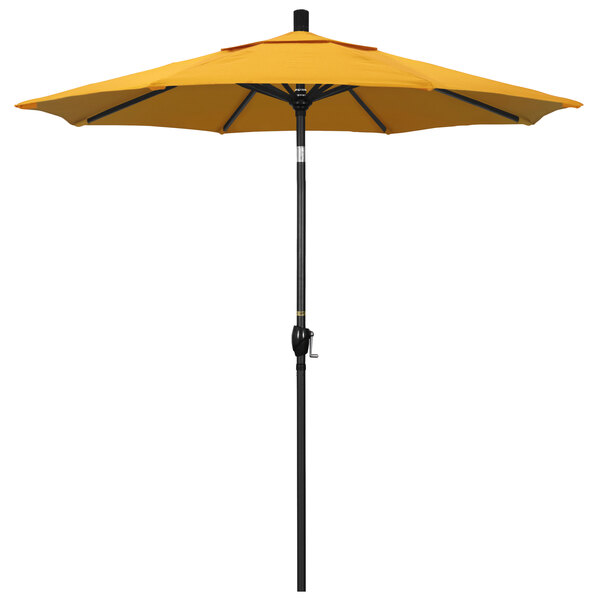 A yellow California Umbrella on a stone black aluminum pole.