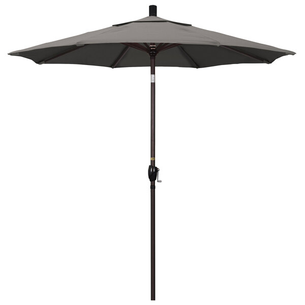 A close-up of a taupe California Umbrella with a bronze pole.