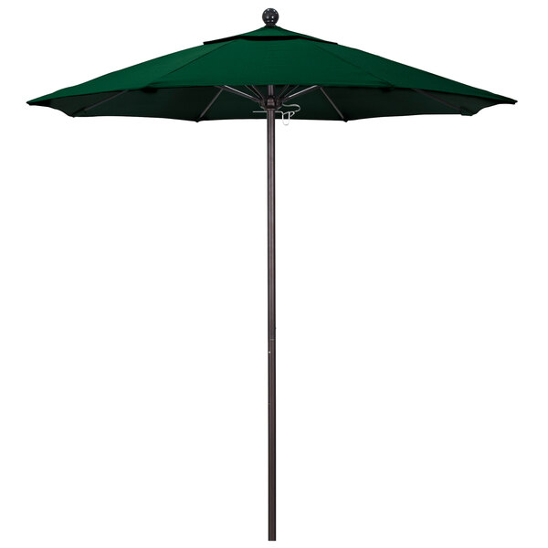 A forest green California Umbrella on a bronze pole.