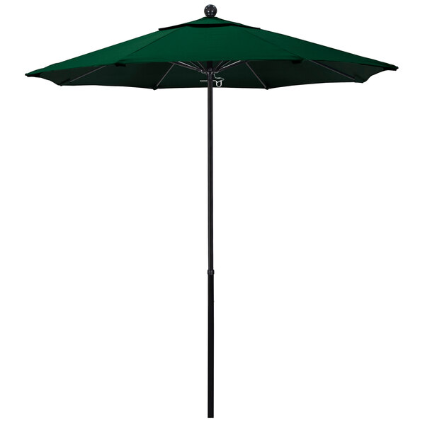 A green California Umbrella with a hunter green canopy on a black pole.