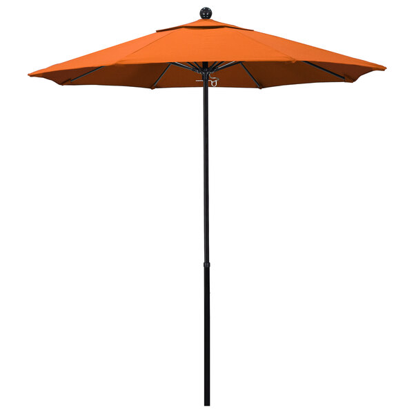 An orange umbrella with a Sunbrella Tuscan canopy on a black pole.
