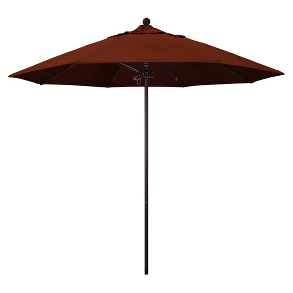 A brown California Umbrella with a bronze pole and red canopy.