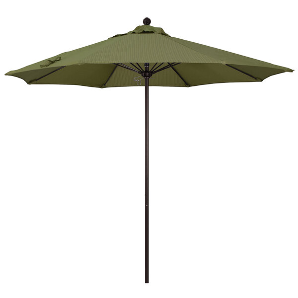 A green California Umbrella on a bronze pole.