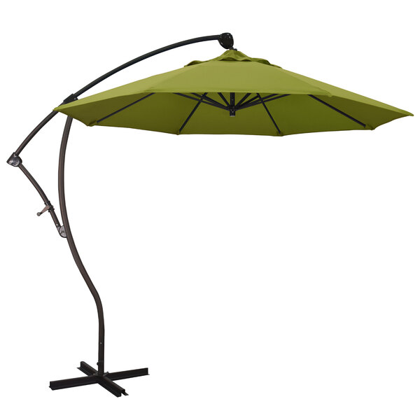 A California Umbrella Bayside cantilever umbrella with a Pacifica Ginkgo canopy over a stand with a black pole.