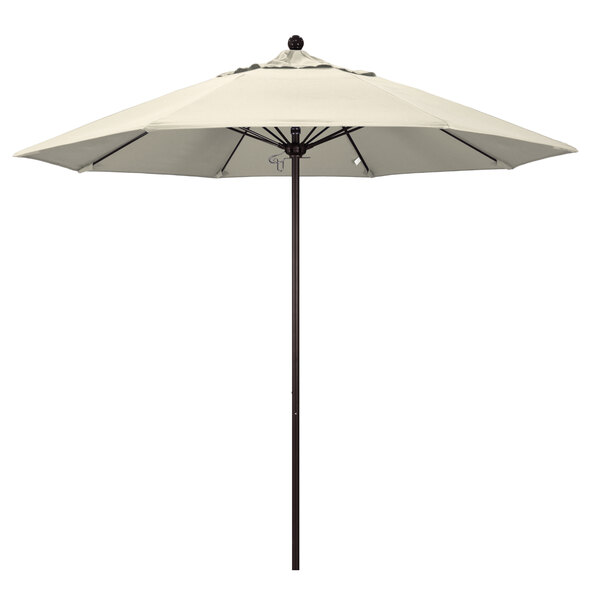 A white umbrella on a bronze pole.