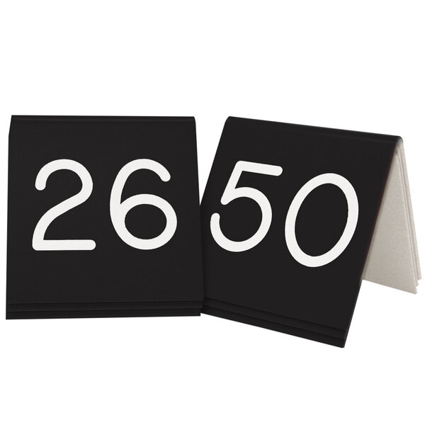 Two black engraved table tents with the numbers 26 to 50.