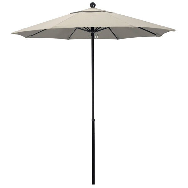 A California Umbrella round beige umbrella with a black pole.