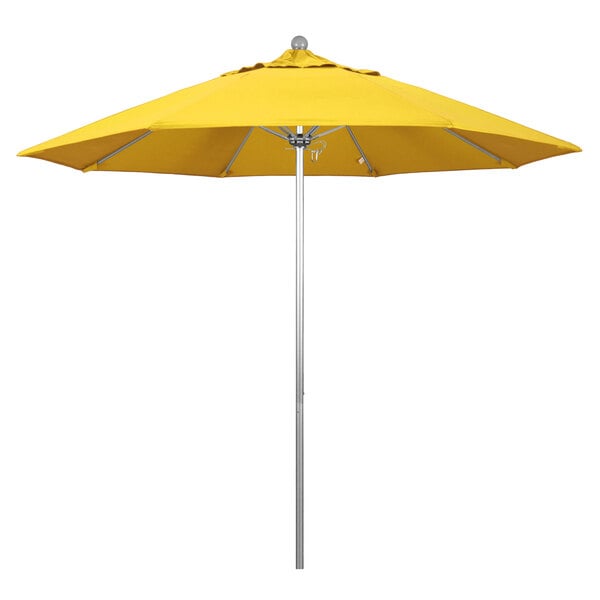 A California Umbrella with a lemon yellow canopy on a silver metal pole.
