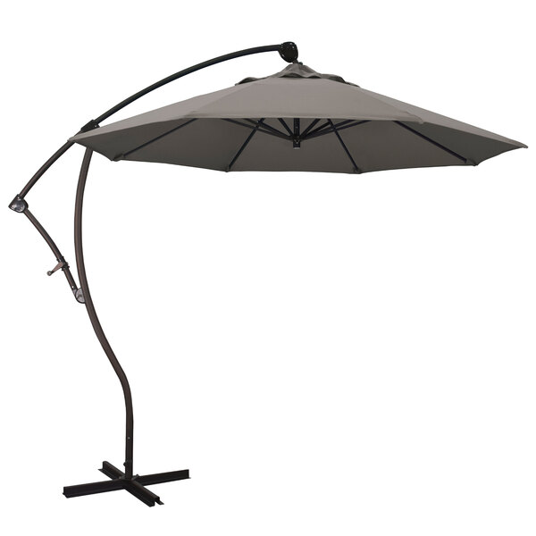 A California Umbrella Bayside cantilever umbrella with a taupe canopy on a metal stand.