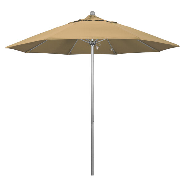 A tan California Umbrella on a silver metal pole.
