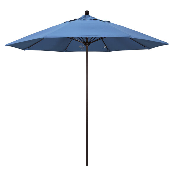 A blue California Umbrella with a bronze pole and a blue canopy.