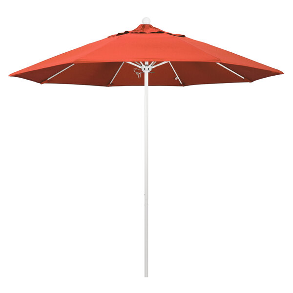 A red California Umbrella with a sunset patterned canopy on a white pole.