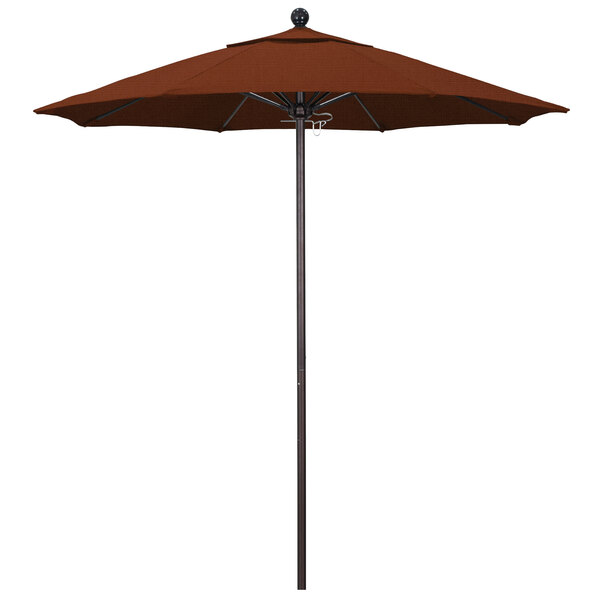 A close-up of a California Umbrella ALTO round terracotta umbrella on a bronze metal pole.
