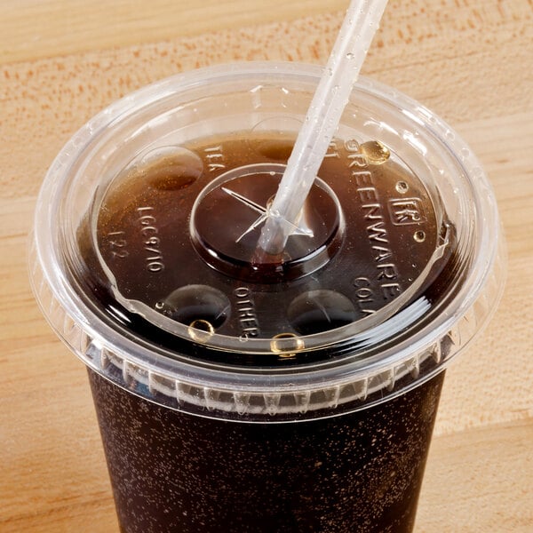 A Fabri-Kal Greenware plastic cup with a straw and a clear plastic lid with a straw slot on it.