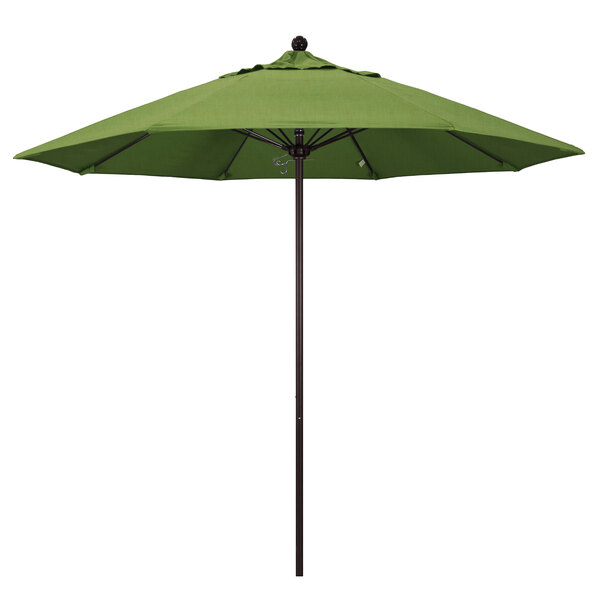 A green California Umbrella on a bronze metal pole.