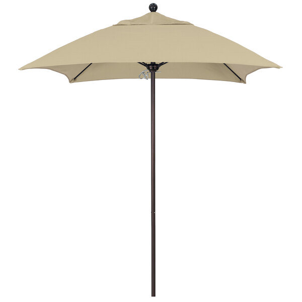 An Antique Beige California Umbrella with a Bronze Pole.