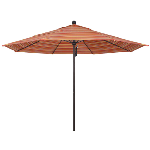 A California Umbrella with a Sunbrella Dolce Mango canopy featuring orange and white stripes on a pole with a bronze finish.