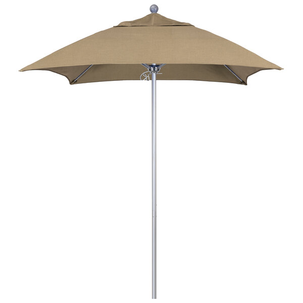 A tan umbrella with a silver pole and tan canopy.