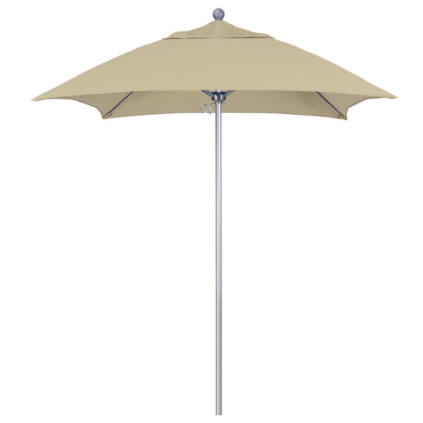 A tan California Umbrella on a silver metal pole.