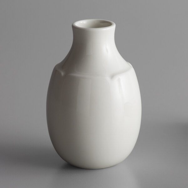 A white RAK Porcelain Anna flower vase on a gray surface.