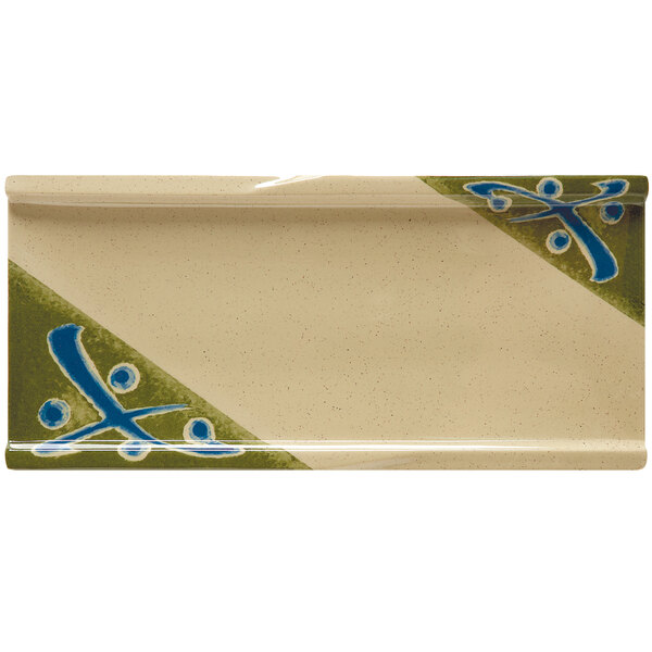 A rectangular white plate with a green and blue design.
