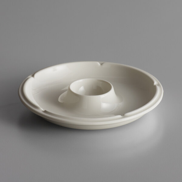 A white round porcelain bowl with a hole in the middle.