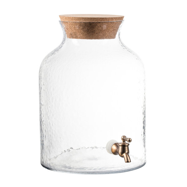 A Stylesetter clear glass beverage dispenser with a cork lid and tap.