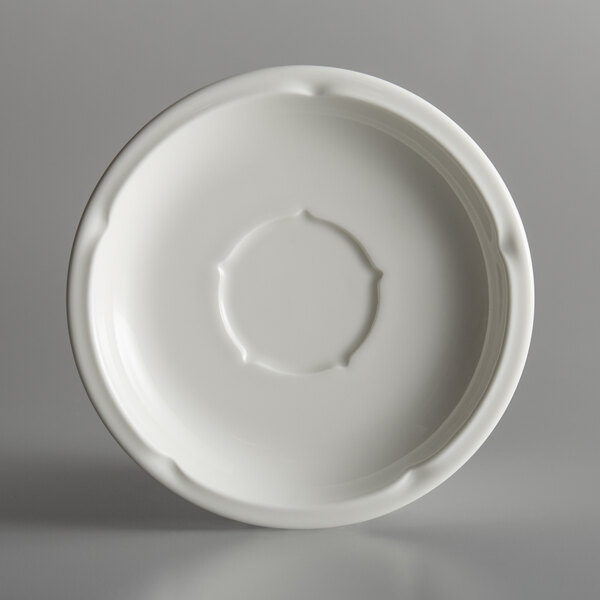 A white porcelain saucer with a circular rim and center circle.
