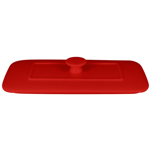 A red rectangular porcelain lid with a round knob.