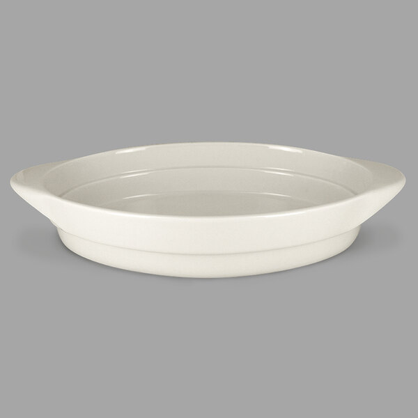 A RAK Porcelain sand white oval serving dish with a handle.