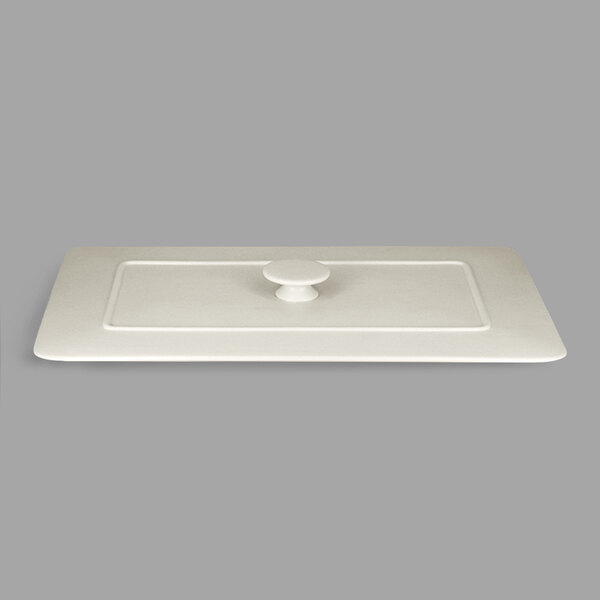 A white rectangular porcelain tureen lid with a handle.