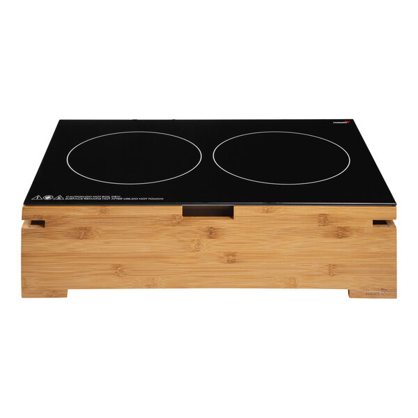 A black countertop with two Rosseto induction heaters with natural bamboo housing.