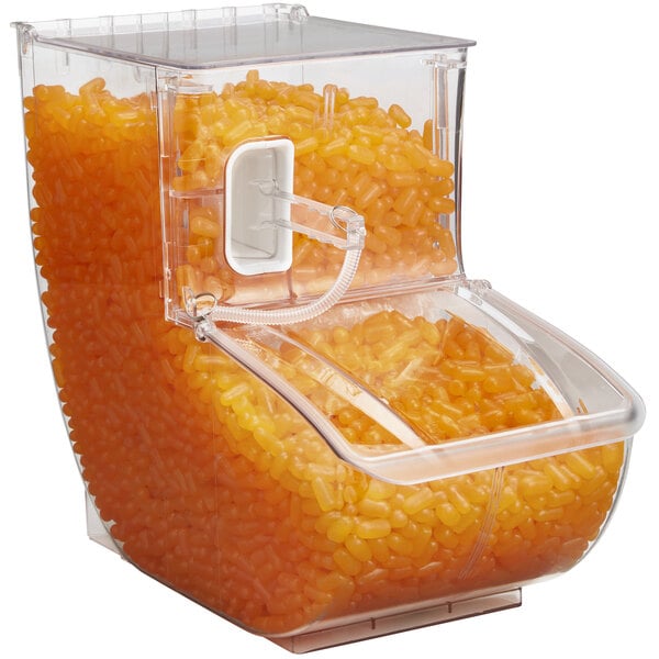 A clear plastic Rosseto bulk bin with a scoop filled with orange grains.