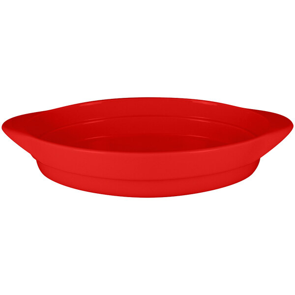 A RAK Porcelain ember red oval serving dish with a curved edge.
