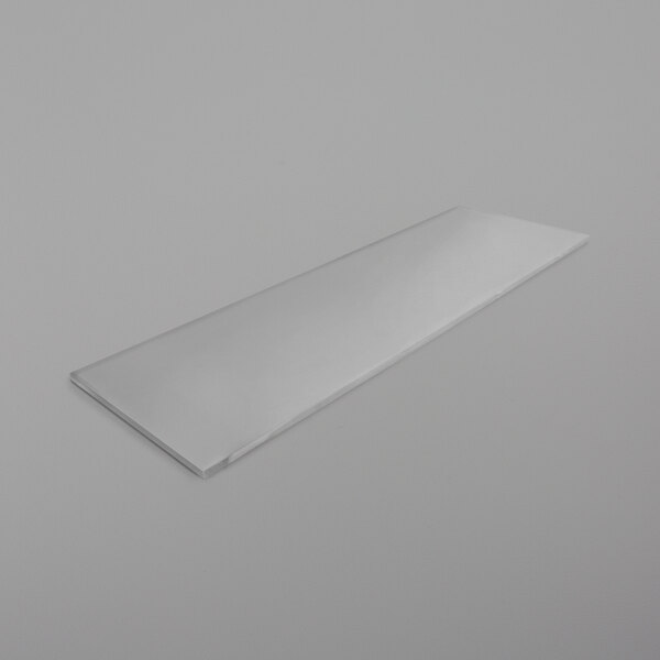 A clear rectangular plastic shelf on a white surface.