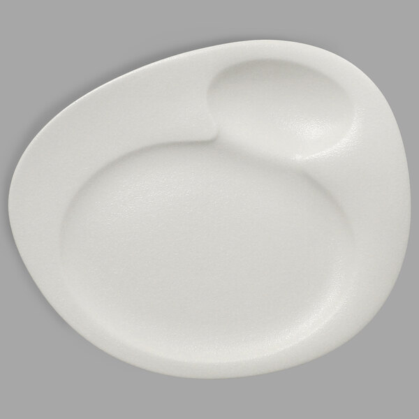 A close-up of a RAK Porcelain Neo Fusion white porcelain plate with a half circle on top.