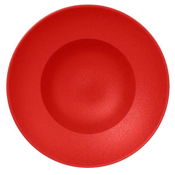 A red porcelain plate with a circle in the middle.