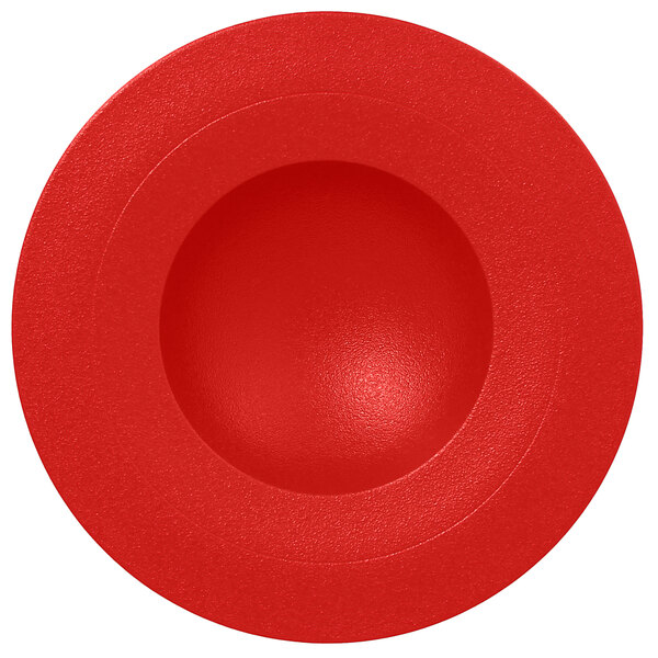 A RAK Porcelain ember red porcelain deep plate with a round center.